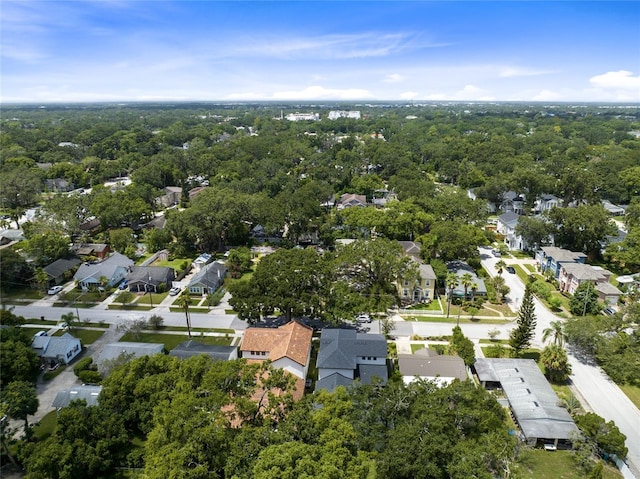 birds eye view of property featuring a residential view and a wooded view