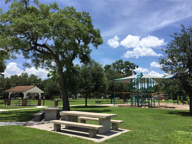 view of home's community featuring a gazebo, playground community, and a lawn