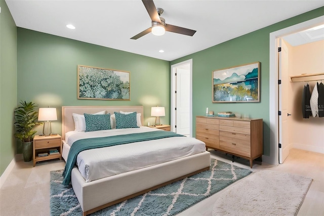 bedroom with a spacious closet, ceiling fan, baseboards, and recessed lighting
