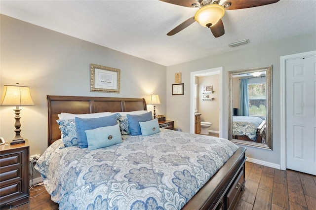 bedroom featuring dark hardwood / wood-style flooring, ceiling fan, and ensuite bathroom