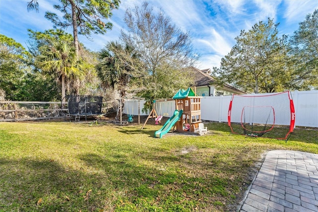 view of jungle gym with a trampoline and a lawn