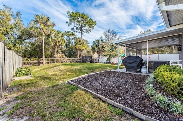 view of yard featuring a patio area and a sunroom