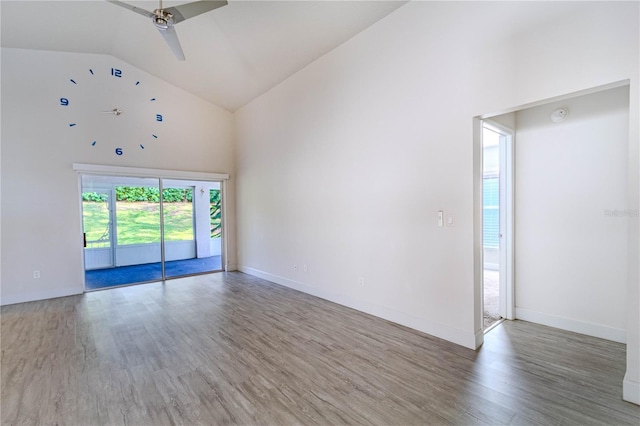 spare room featuring hardwood / wood-style flooring, ceiling fan, and high vaulted ceiling