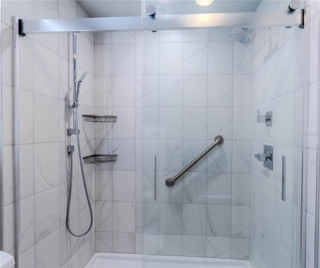 bathroom with a shower with shower door