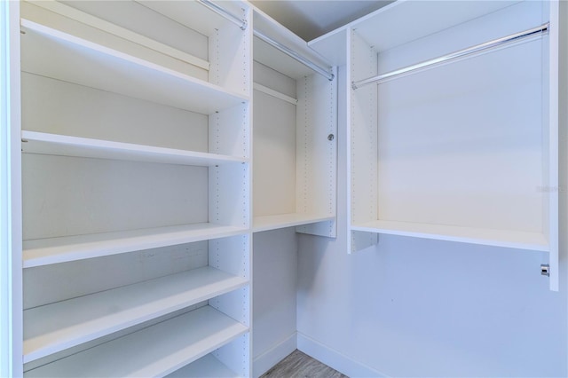 spacious closet featuring hardwood / wood-style floors