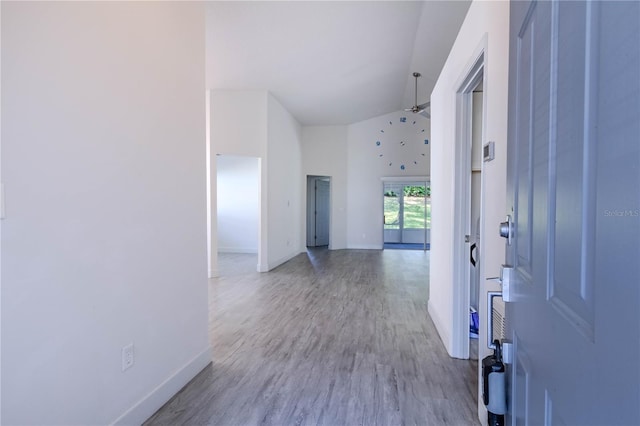 entrance foyer with a towering ceiling and light wood-type flooring