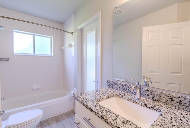 full bathroom featuring vanity, toilet, and tiled shower / bath