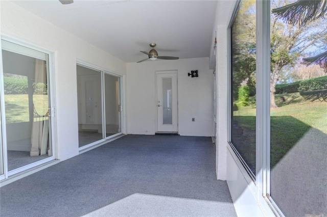 sunroom featuring ceiling fan