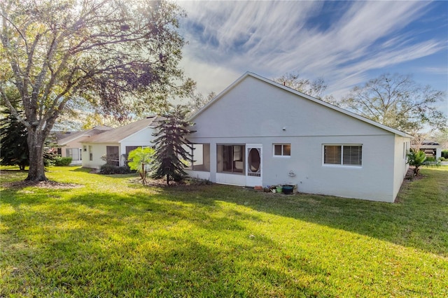 rear view of house featuring a lawn