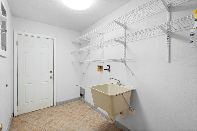 clothes washing area featuring hookup for a washing machine, sink, and electric dryer hookup