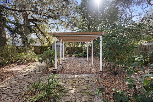 view of yard with a storage shed and a pergola