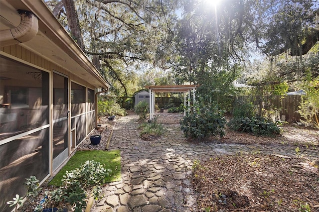 view of yard with a storage shed and a sunroom