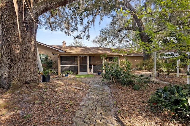 rear view of property with a sunroom