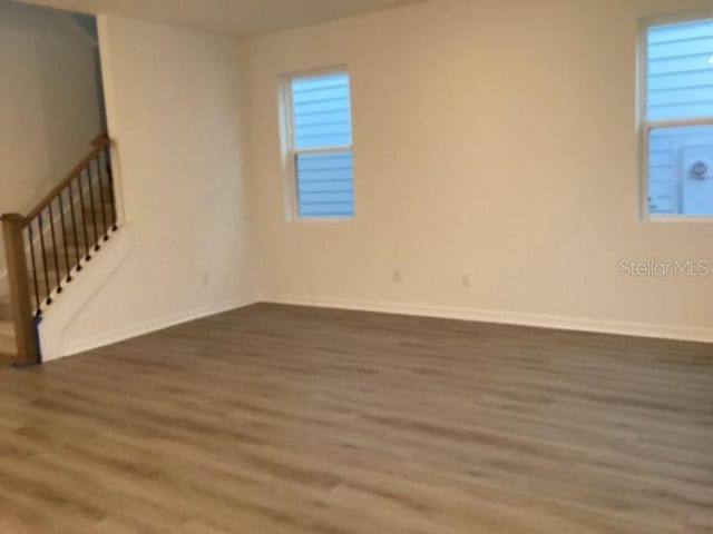 spare room with dark hardwood / wood-style floors