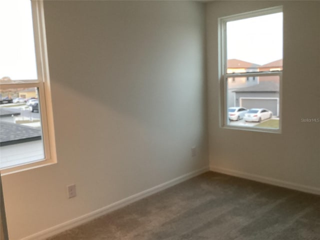 empty room with dark colored carpet