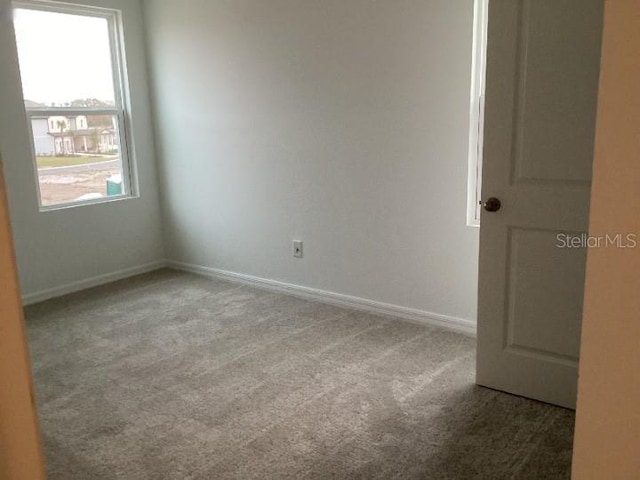 spare room with light colored carpet