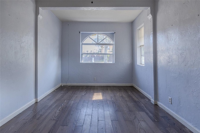 spare room with dark hardwood / wood-style floors