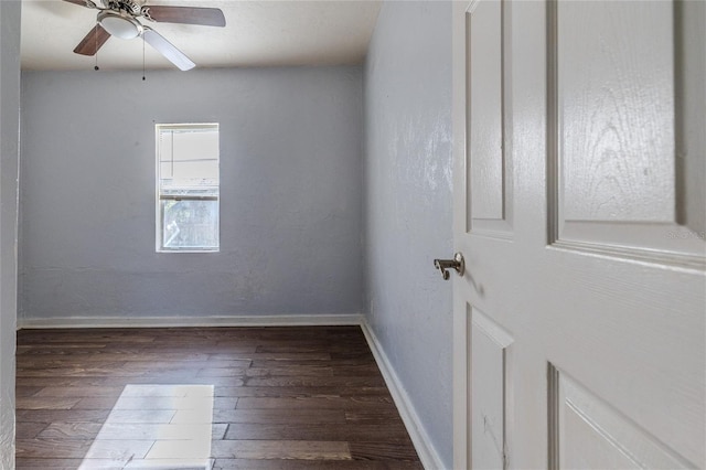 unfurnished room with dark wood-type flooring and ceiling fan