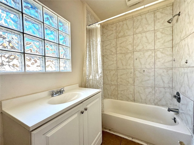 bathroom featuring vanity and shower / bathtub combination with curtain