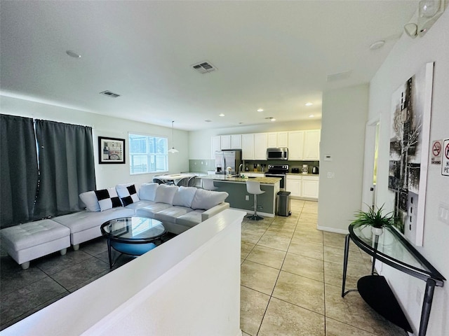 living room with sink and light tile patterned floors