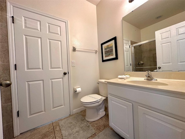 bathroom featuring an enclosed shower, vanity, tile patterned flooring, and toilet