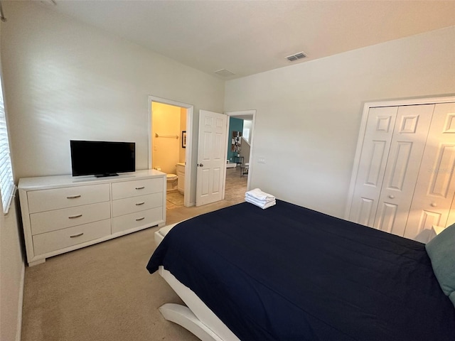 bedroom featuring light carpet and a closet