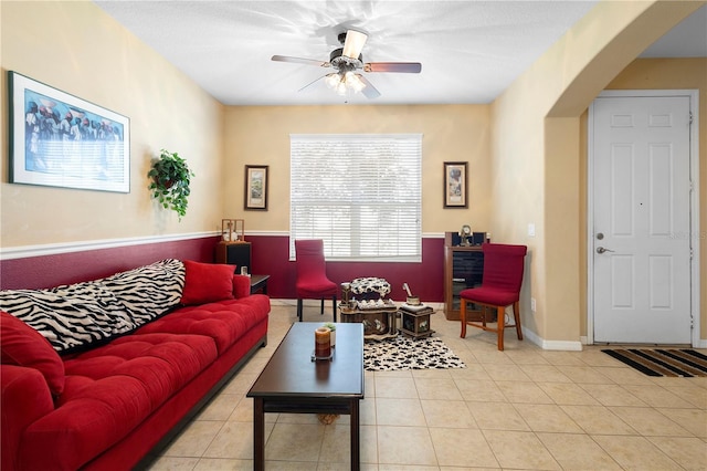 tiled living room with ceiling fan