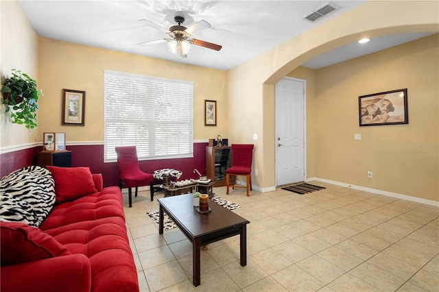 living room featuring light tile patterned flooring and ceiling fan