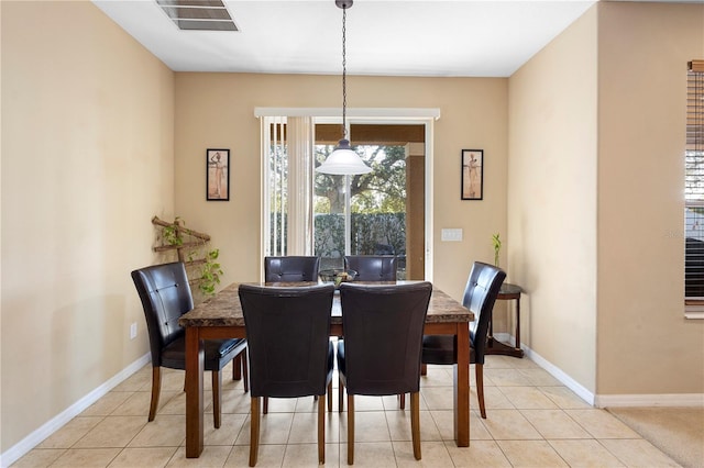 dining area with light tile patterned floors