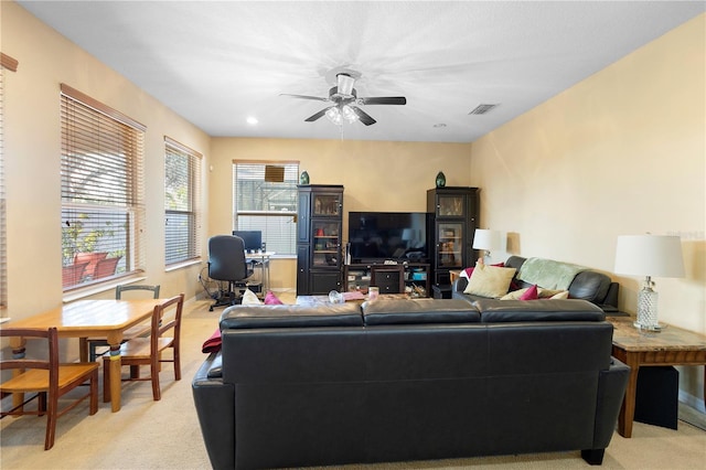 living room with ceiling fan and light carpet