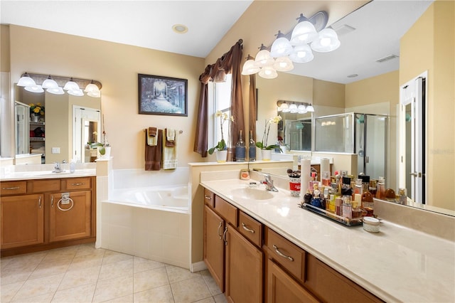 bathroom featuring independent shower and bath, vanity, and tile patterned floors