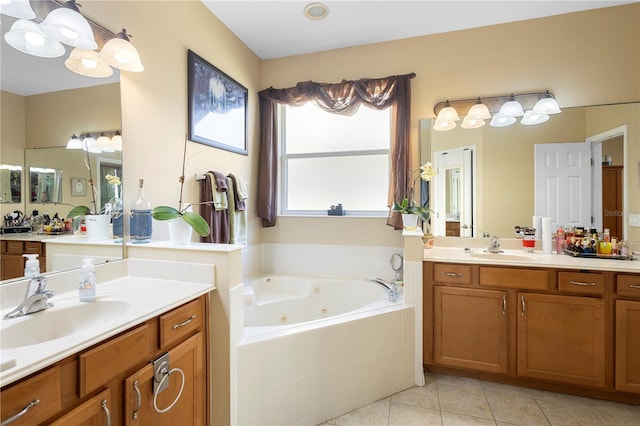 bathroom featuring tile patterned floors, vanity, and tiled tub