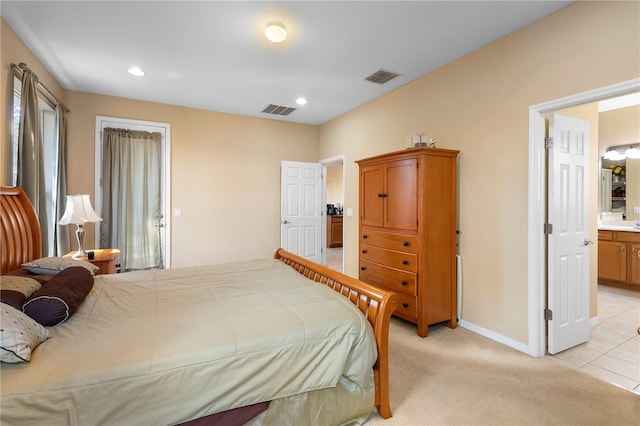 carpeted bedroom with ensuite bathroom