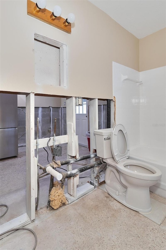 bathroom with toilet and a shower