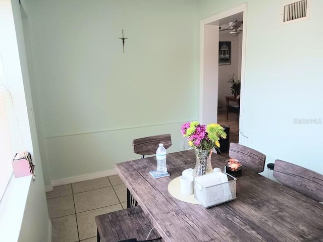 dining space with light tile patterned floors, visible vents, and baseboards