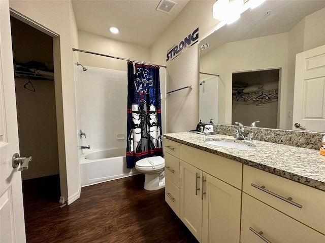 full bathroom featuring vanity, hardwood / wood-style flooring, toilet, and shower / bath combo