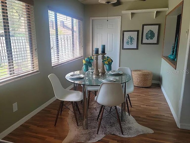 dining space with dark wood-type flooring