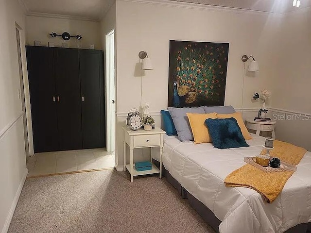 bedroom with crown molding and carpet flooring