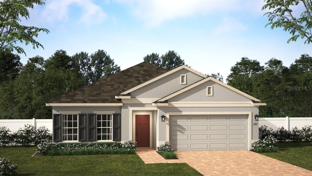 view of front of property featuring a garage and a front yard