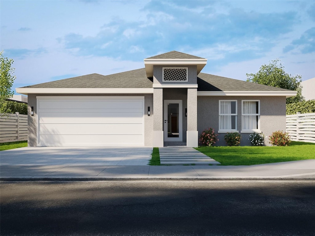 view of front facade with driveway, an attached garage, fence, a front lawn, and stucco siding