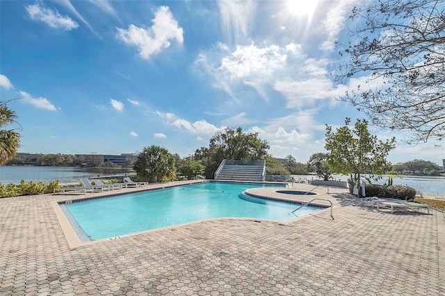 pool with a water view and a patio
