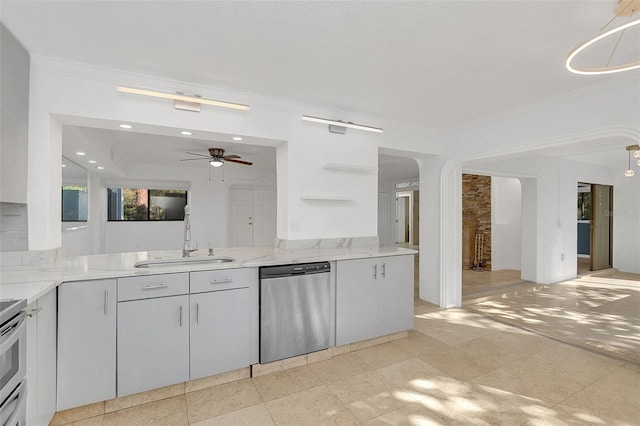 kitchen featuring stainless steel dishwasher, arched walkways, open shelves, a ceiling fan, and a sink