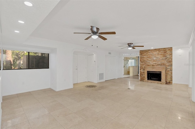 unfurnished living room with visible vents, ceiling fan, recessed lighting, a large fireplace, and light tile patterned flooring