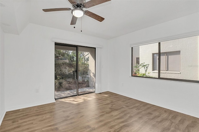 unfurnished room featuring ceiling fan, baseboards, and wood finished floors