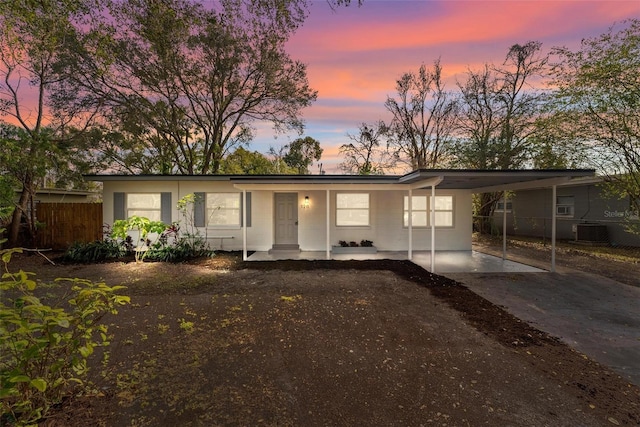 ranch-style house with a carport and cooling unit