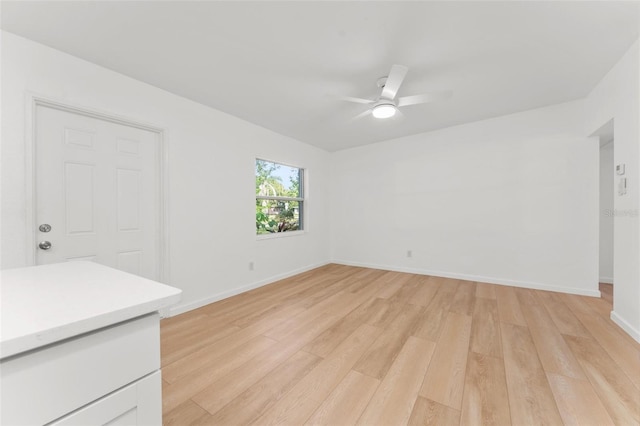 unfurnished living room with ceiling fan and light hardwood / wood-style floors