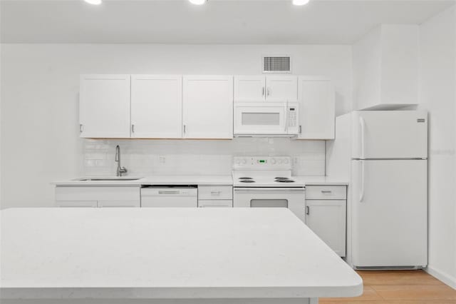 kitchen with sink, white cabinetry, light hardwood / wood-style flooring, white appliances, and backsplash