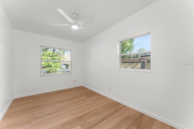 empty room featuring ceiling fan, light hardwood / wood-style floors, and a healthy amount of sunlight