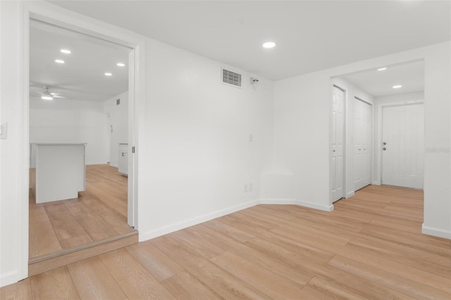 unfurnished room featuring ceiling fan and light hardwood / wood-style floors