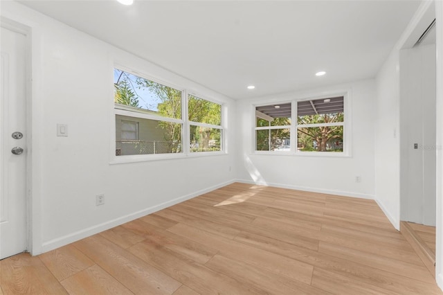 unfurnished room with light hardwood / wood-style flooring